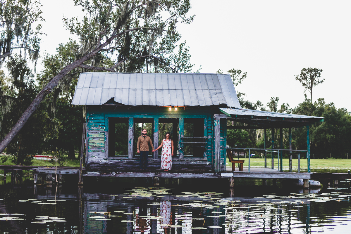 boat house, lake, water, couple, holding hands