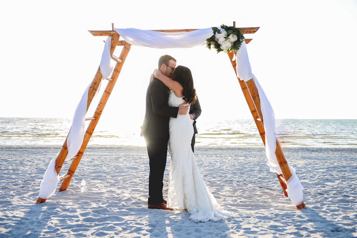 beach, wedding, bride, groom, first kiss, ocean, sun