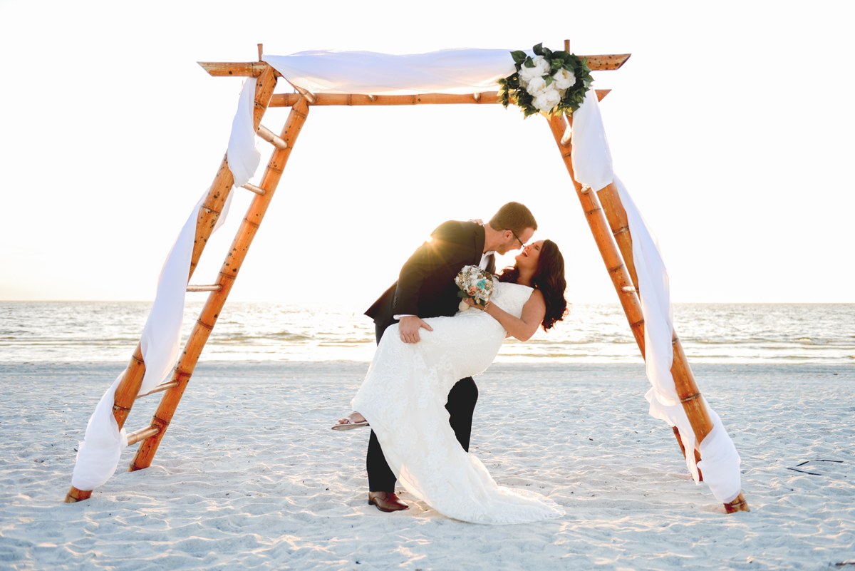 husband, wife, beach, laughing, just married, sun flare