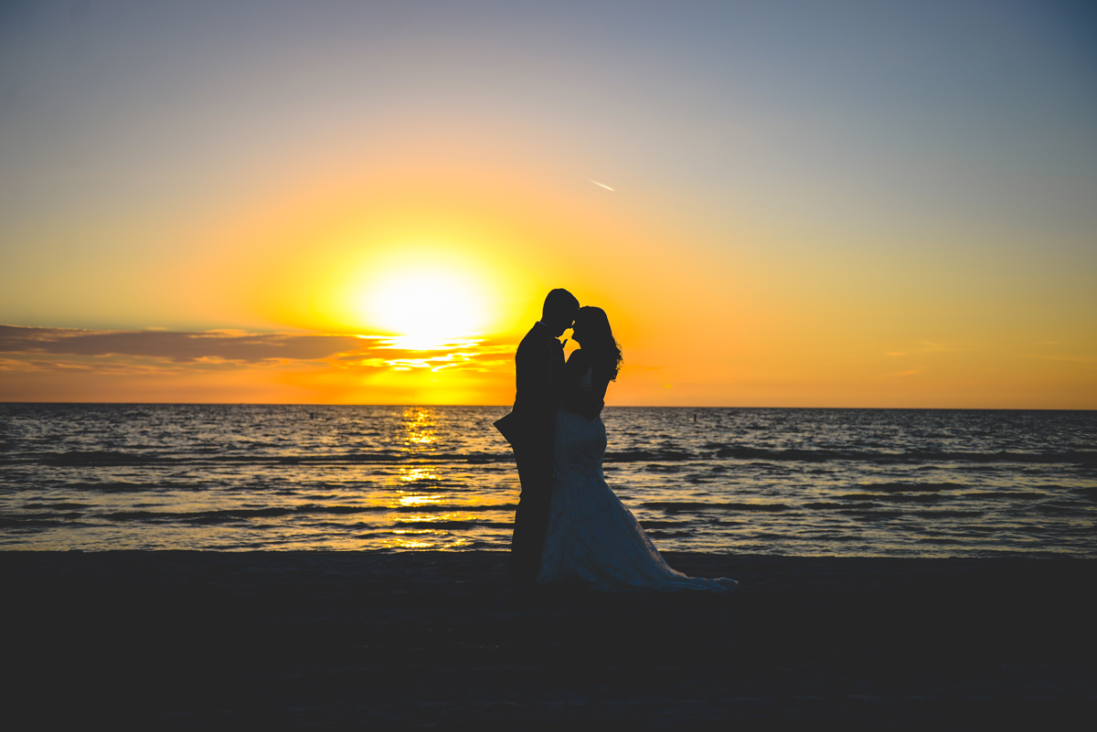 silhouette, sunset, beach, ocean, bride, groom