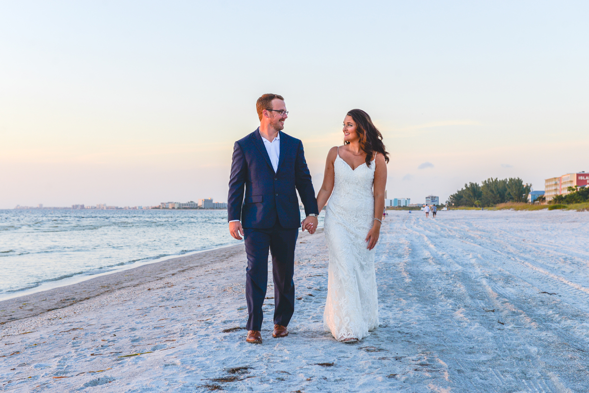 beach, holding hands, ocean, walking, wedding dress
