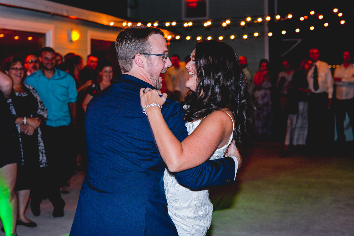 laughing, first dance, sting lights, guests, wedding