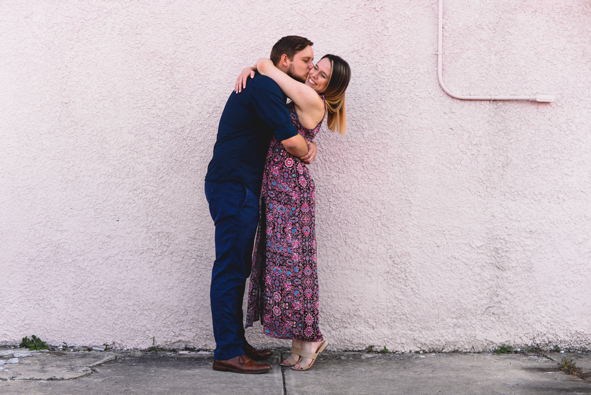 kissing, pink wall, love, couple, engaged, hugging 