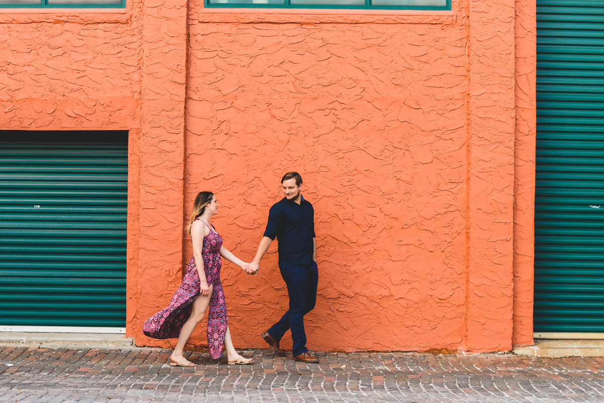 walking, holding hands, couple, bricks, orange, green