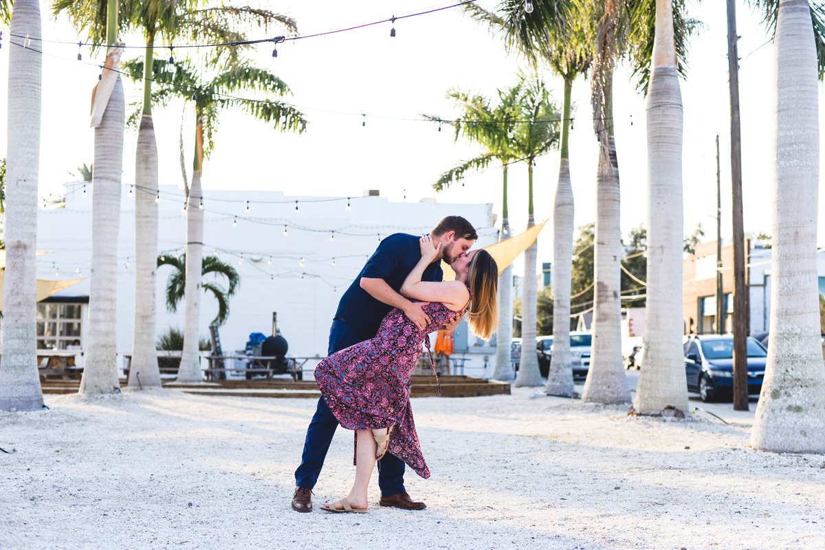 palm trees, string lights, sand, kissing, dress, couple