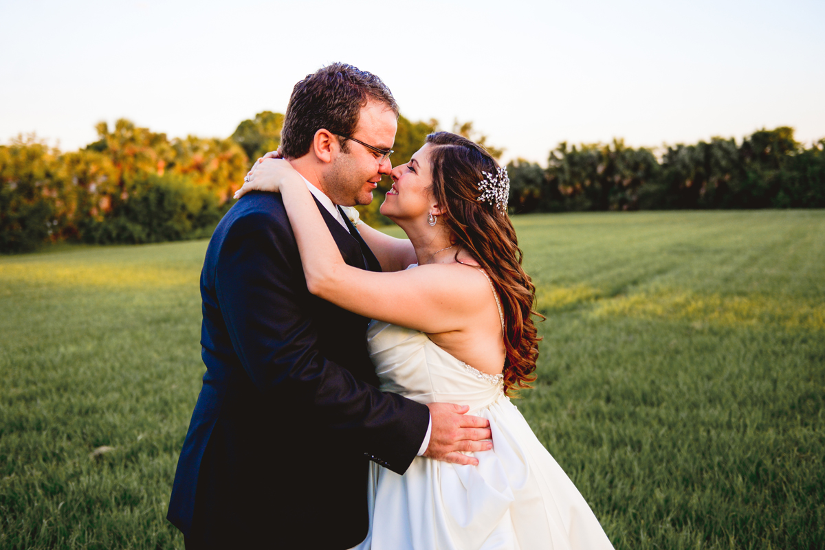 bride, groom, portrait, hugging, kissing, grass