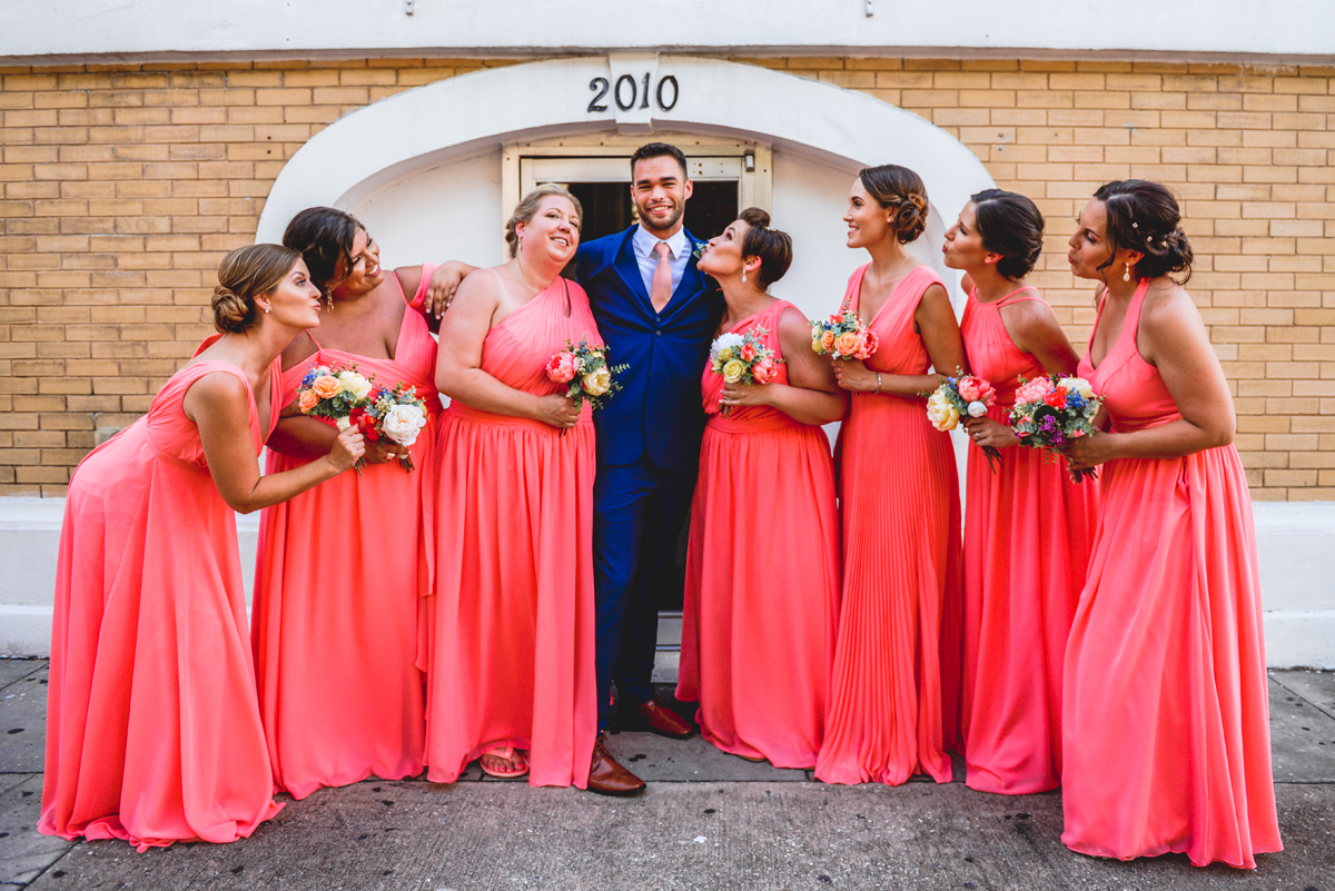 groom, bridesmaids, kissing, posing