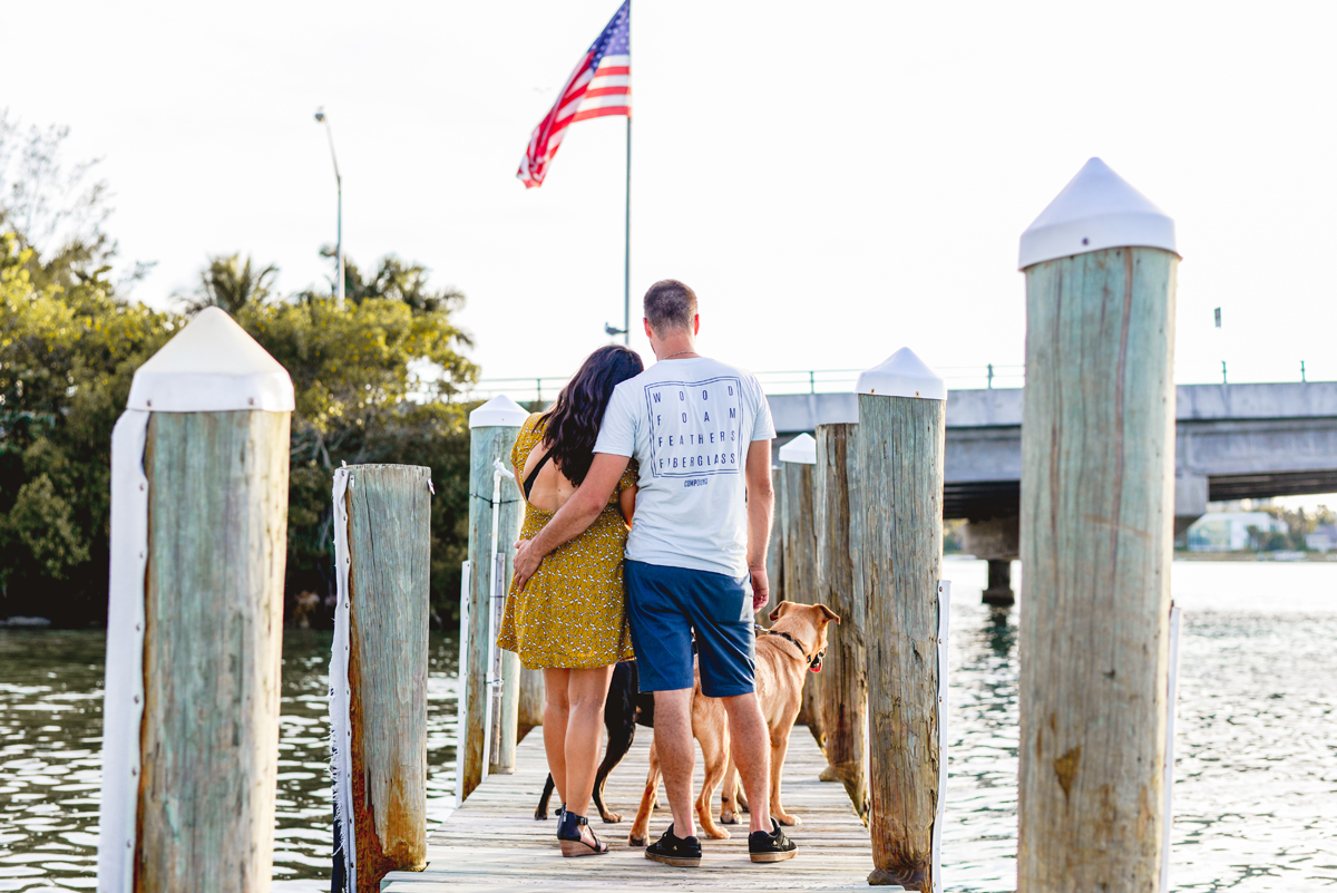dock, flag, water, dogs, couple, beach